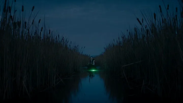 A green glow deep in a night channel